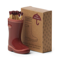 red ceramic wellington boots holding matches